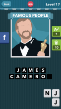 A man with a tan beard in a suit holding a Academy Award|Famo